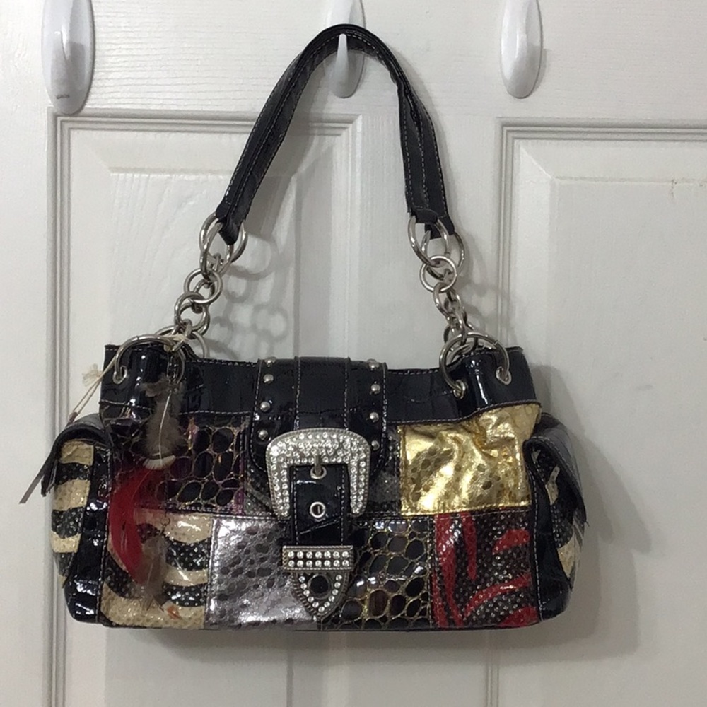 Black lookalike Coach bag design w/ detachable feather decoration.